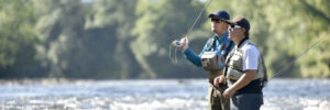 flyfisherman with fishing guide in river