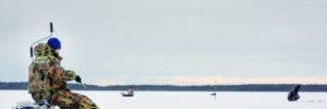 Man fishing on ice during winter months