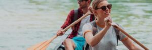 A man and woman enjoy a canoe trip through a remote river